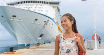 Cruise ship passenger leaving boat for shore excursion in harbour. Asian woman tourist spending a day in port of call of Caribbean travel destination.