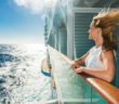 Smiling woman enjoying a day on a cruise ship and looking at view.